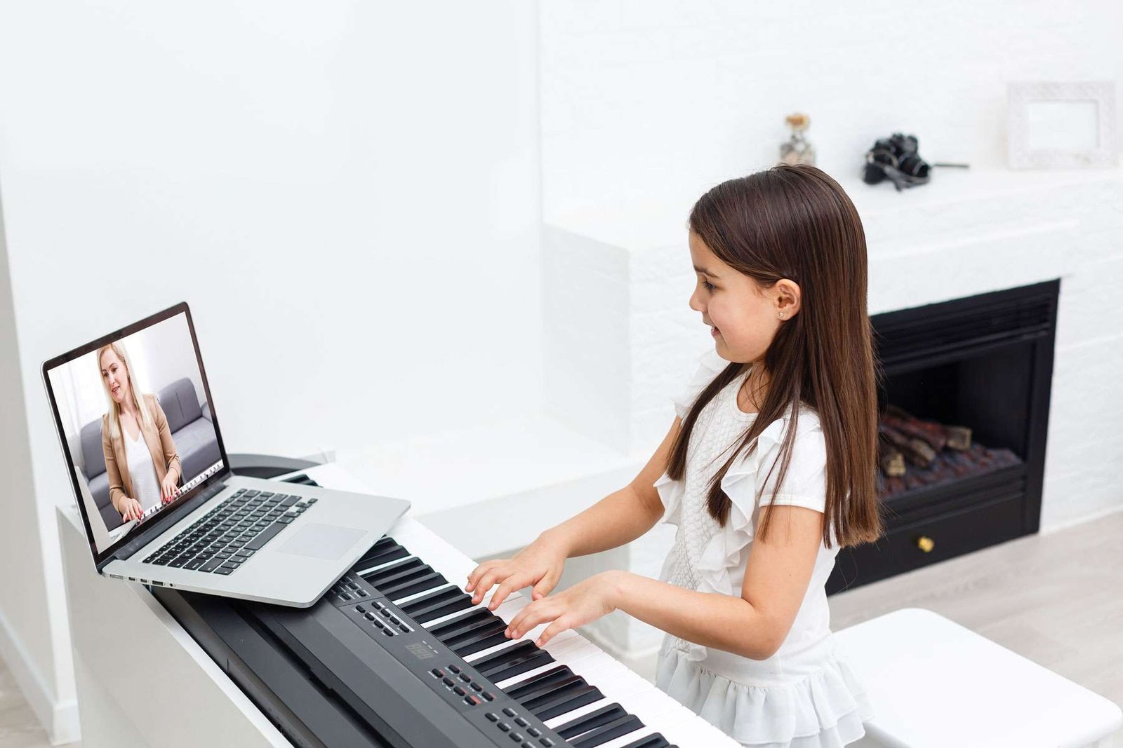 A beginner child learning how to play the piano via online