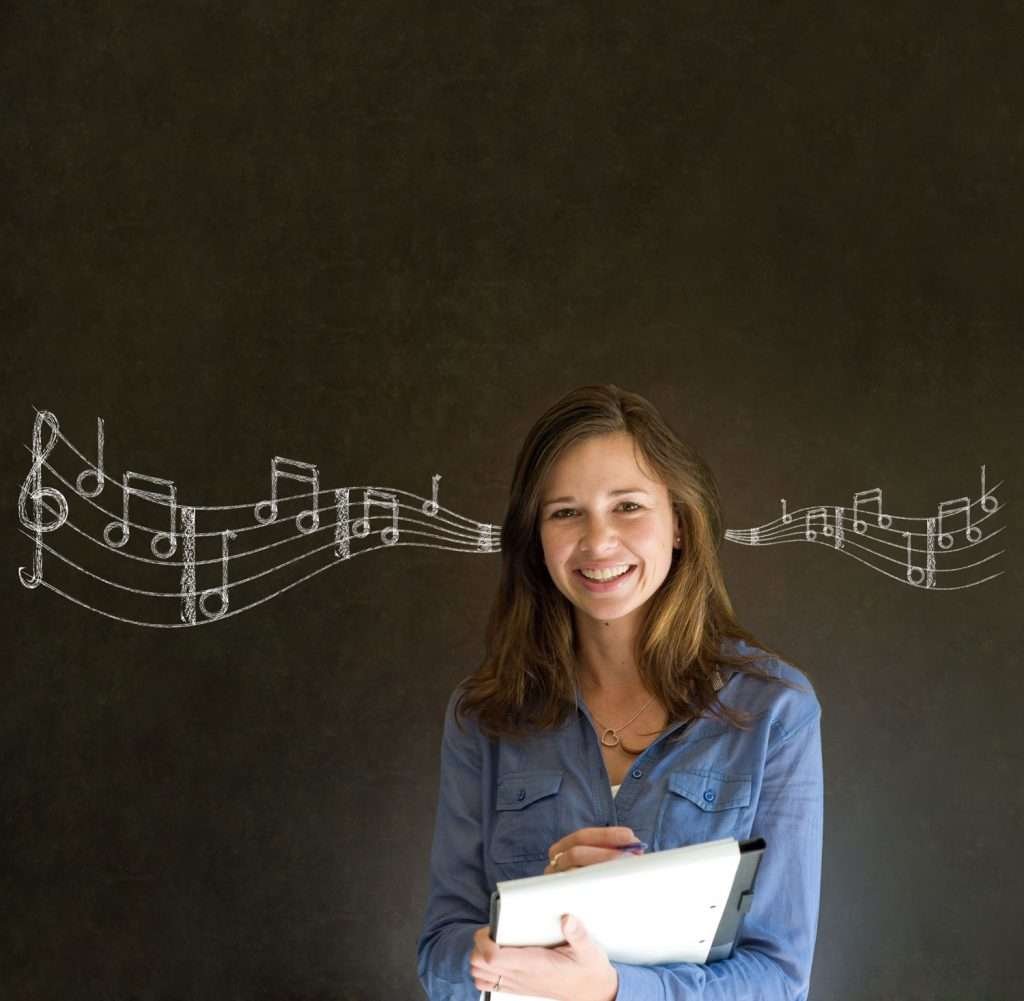 woman in front of chalkboard with staff drawn across