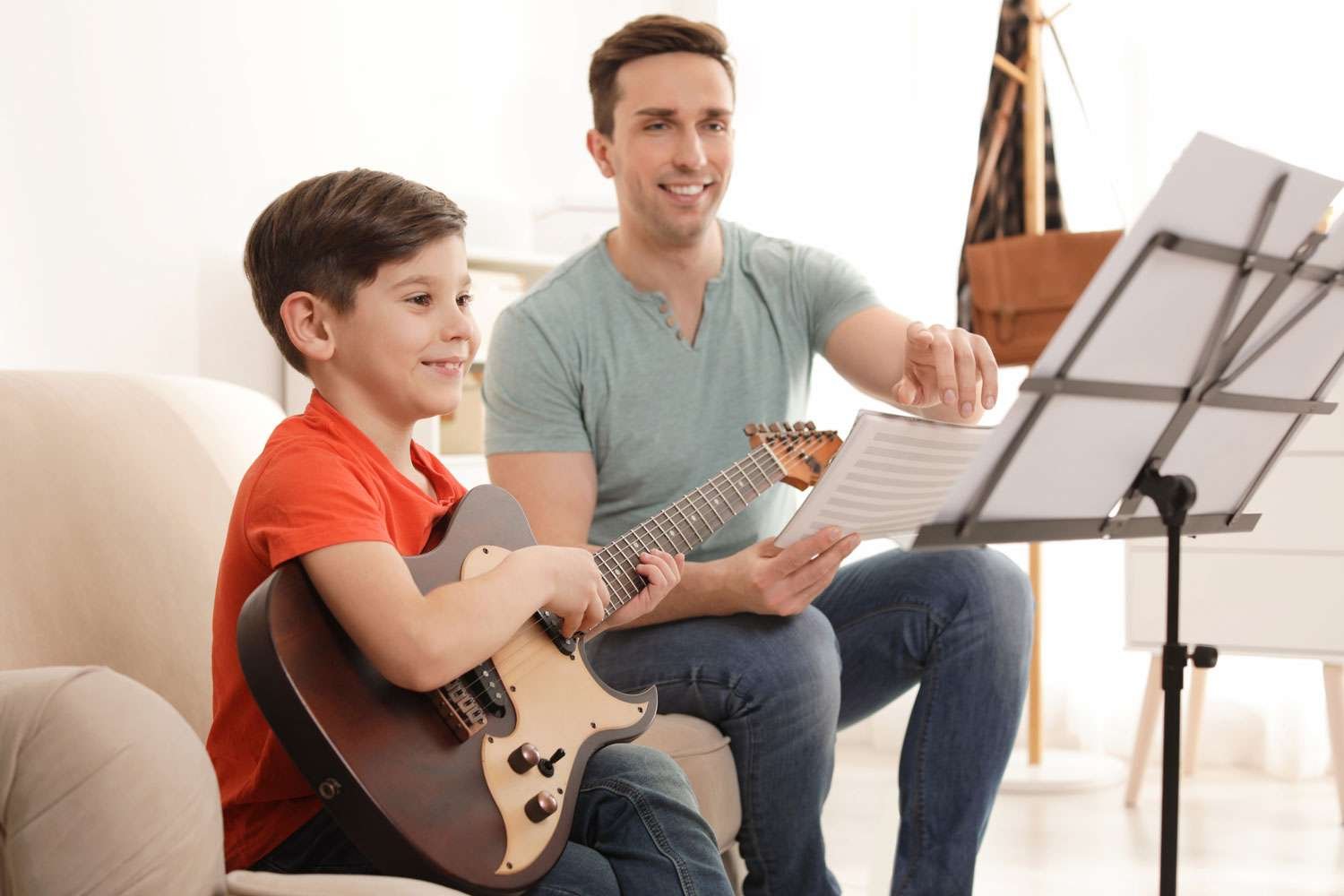 young guitar instructor together with his student