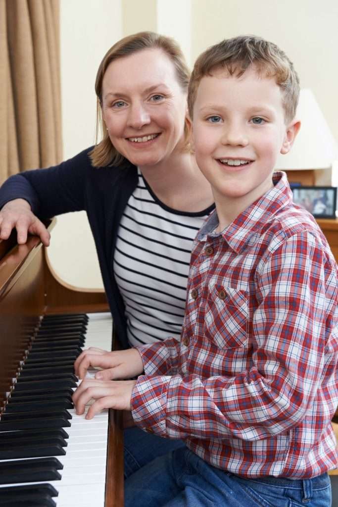 piano instructor with her young boy student