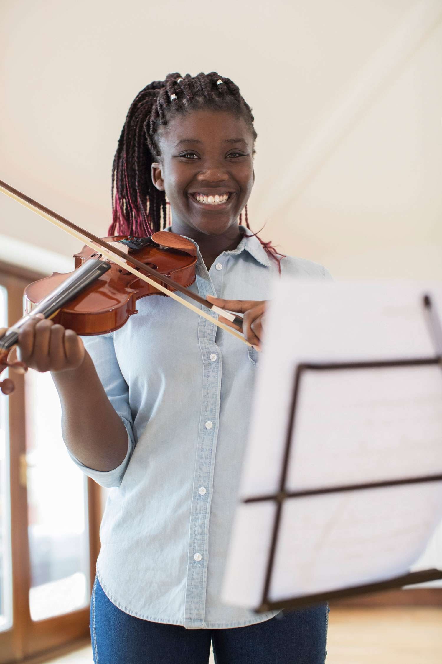 young violin student smiling at the camera