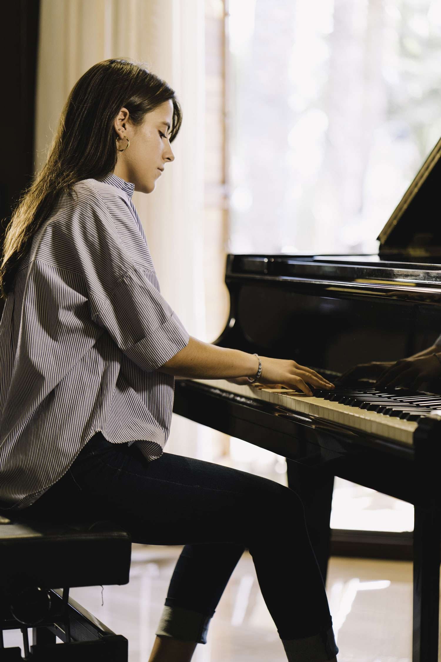 young woman playing the piano