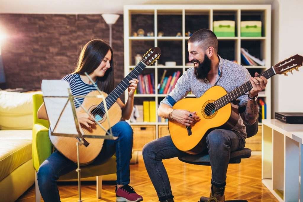 at home guitar lesson with student and teacher